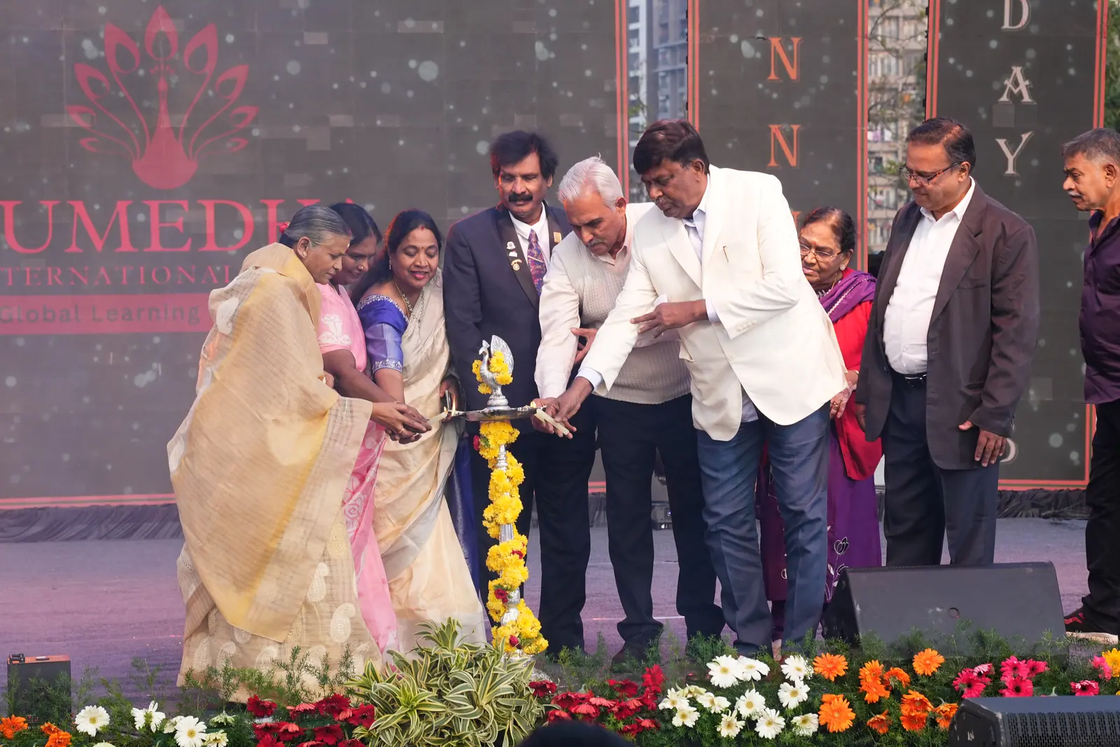 Guests lighting the ceremonial lamp to open the Annual Day celebration
