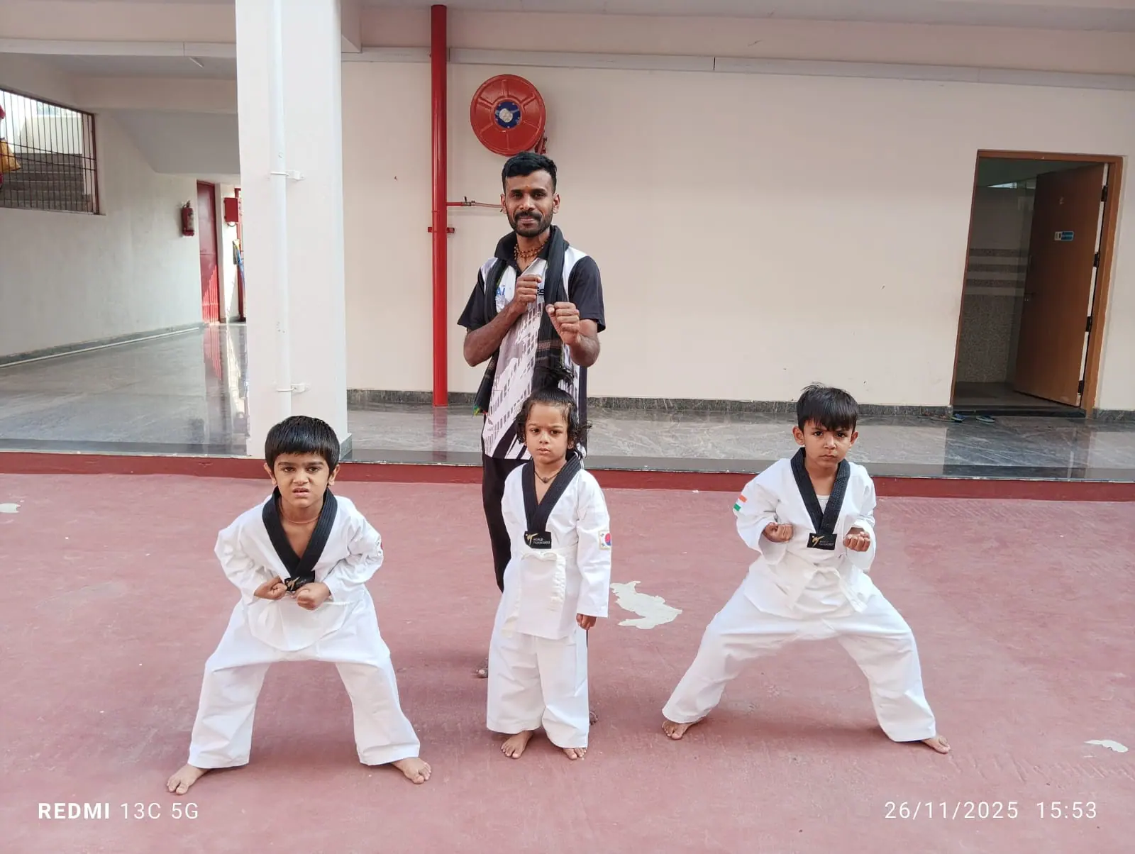 Students in white uniforms practising taekwondo